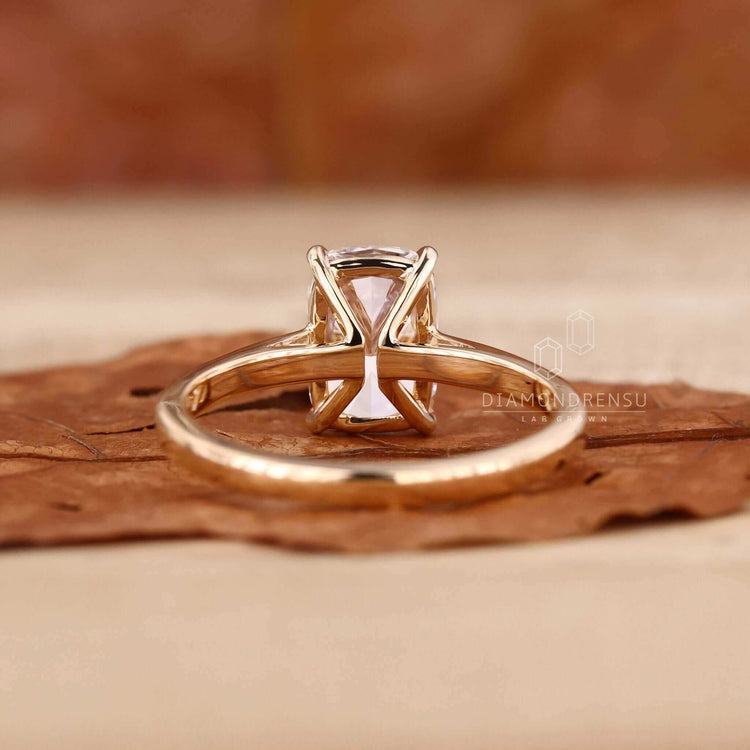 Diamond solitaire ring featuring a handmade elongated cushion cut design.