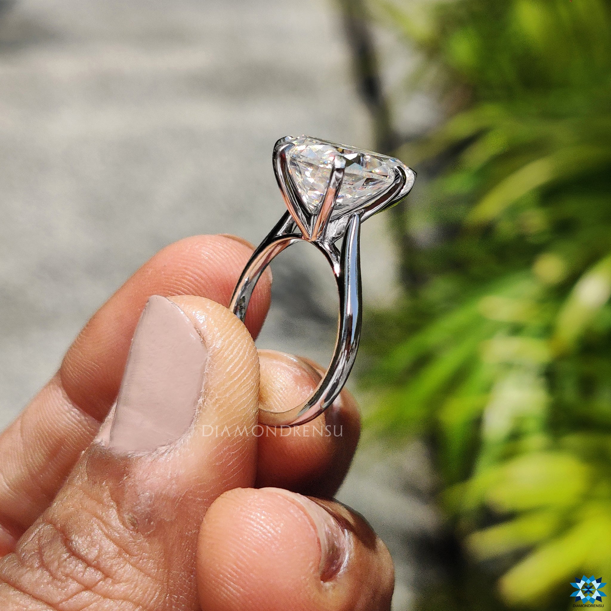 Pear cut moissanite solitaire ring with V prong and cathedral details in white gold.
