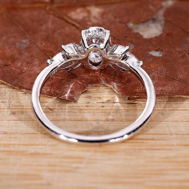 Oval ring crafted with a marquise cut diamond and side stones marquis diamond for a unique engagement ring.
