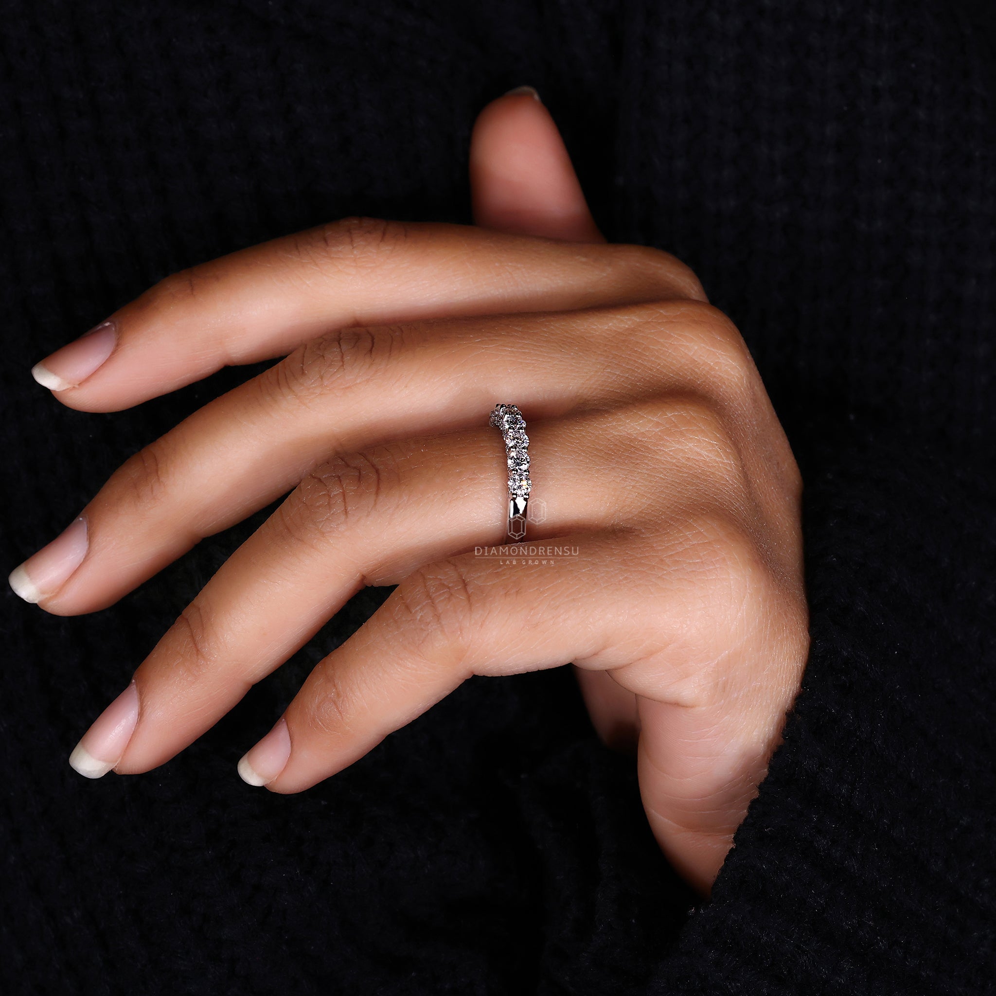 White gold wedding band with round diamonds.
