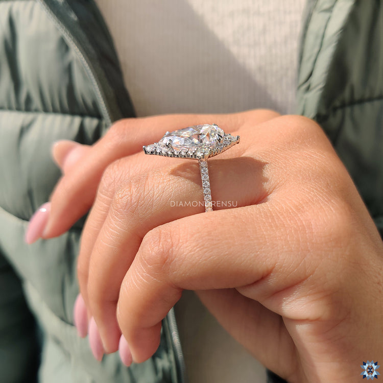 Pear shaped ring in halo engagement ring style
