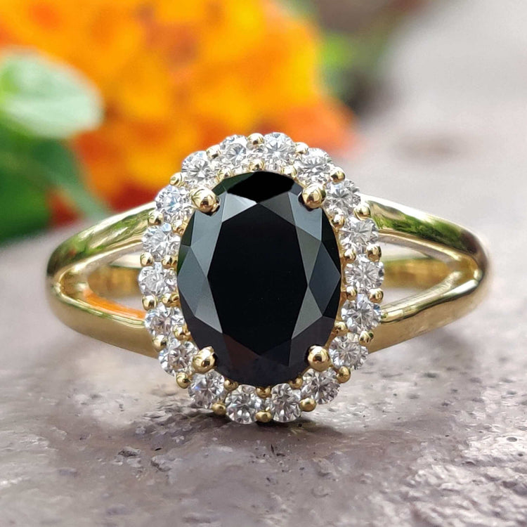 Black moissanite ring with oval cut stone.
