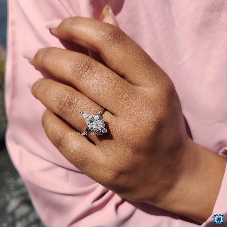 White gold kite cut moissanite ring with compass prongs and half halo.
