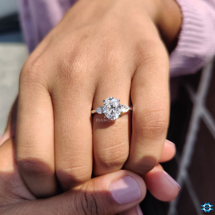 Diamondrensu UK engagement ring with 4 claw prong three stone mount.
