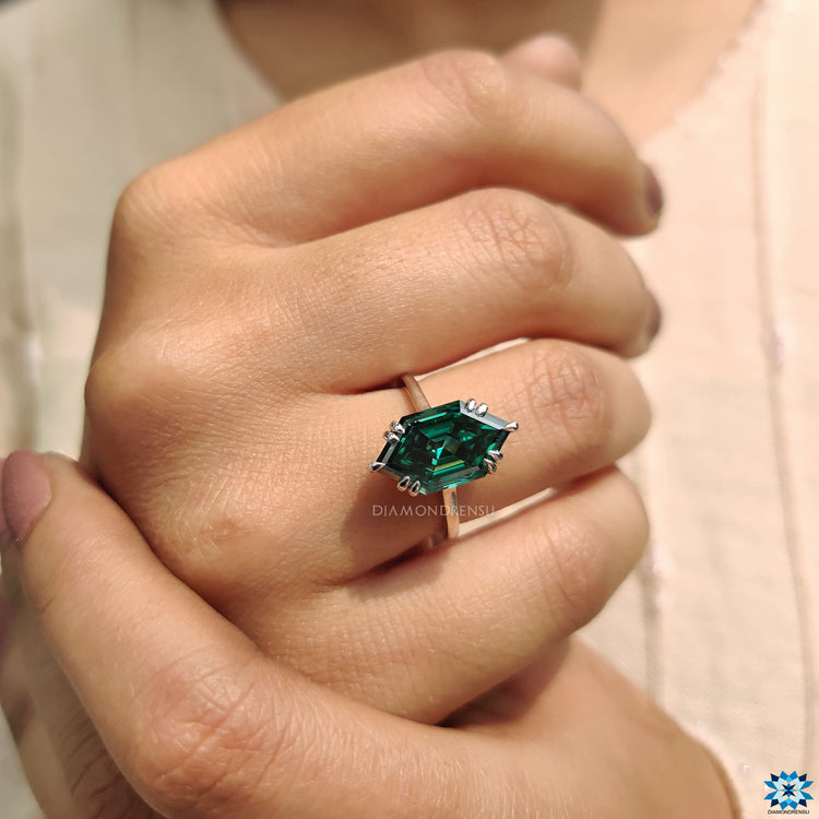 Green moissanite ring set in solitaire style with double claw prongs.
