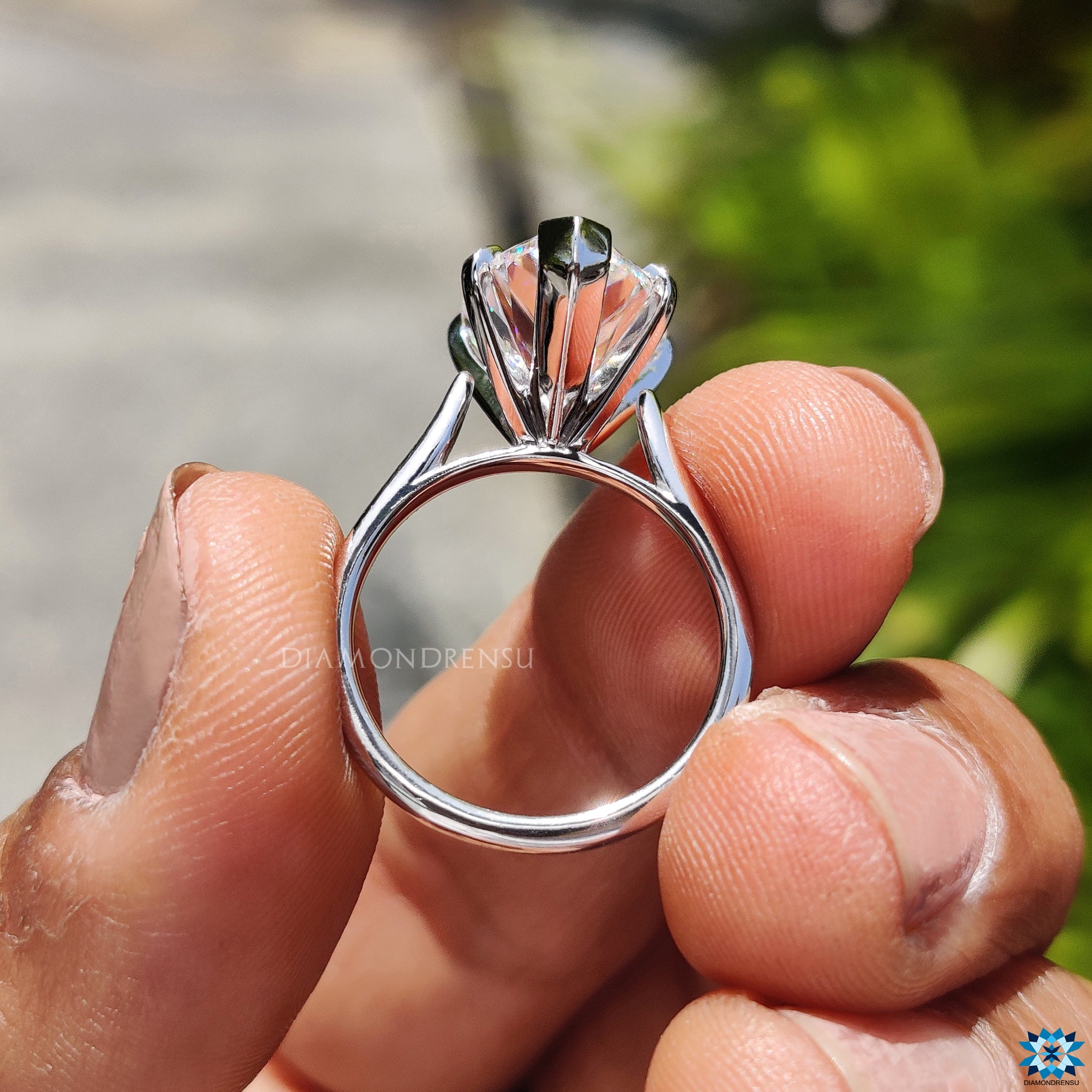 UK engagement ring with pear shaped moissanite in elegant cathedral setting.
