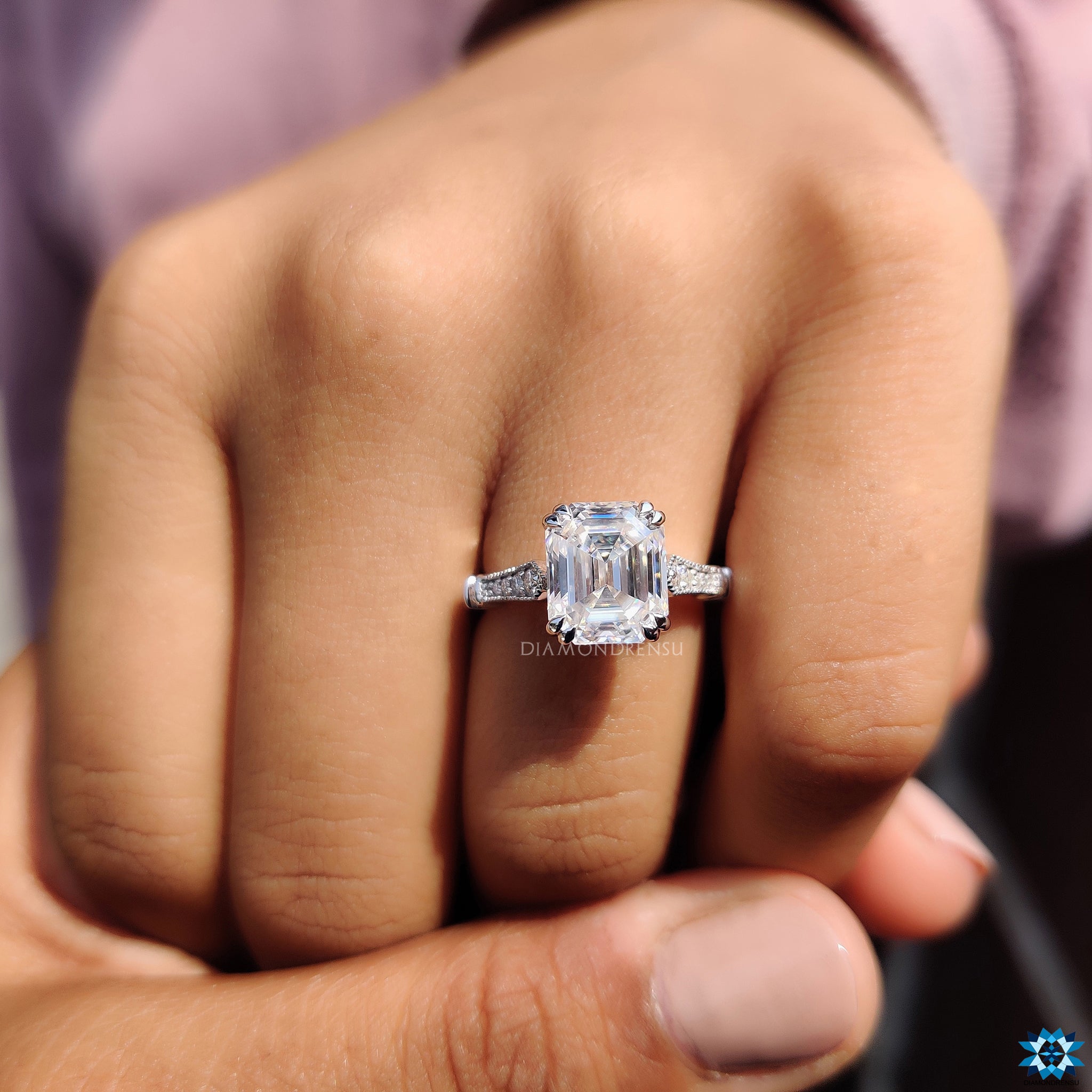 Cathedral setting ring with emerald cut moissanite and vintage-inspired details.
