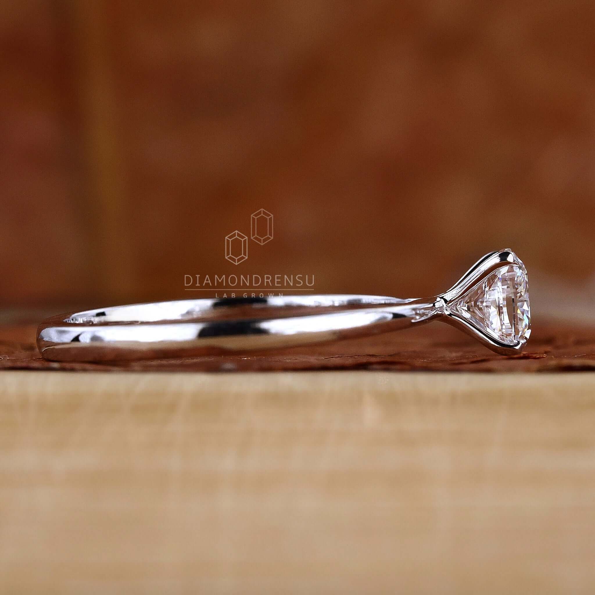 White gold ring showcasing a claw prong design and cushion diamond.