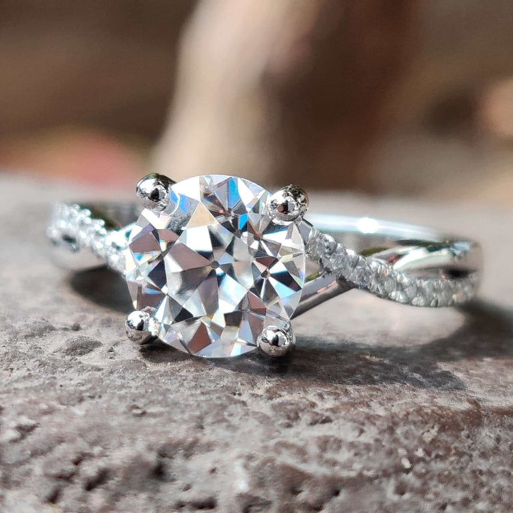 Round old European cut moissanite engagement ring in white gold.
