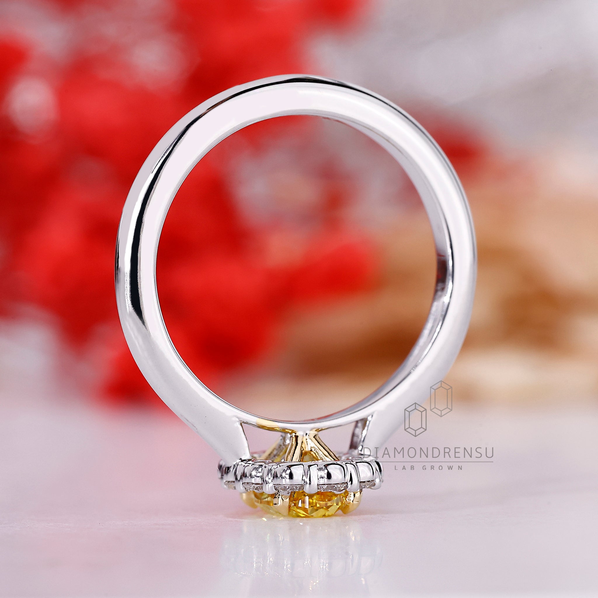 White gold ring with oval and round diamonds.
