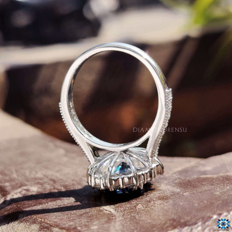 Custom moissanite engagement ring with vintage-inspired milgrain edges.
