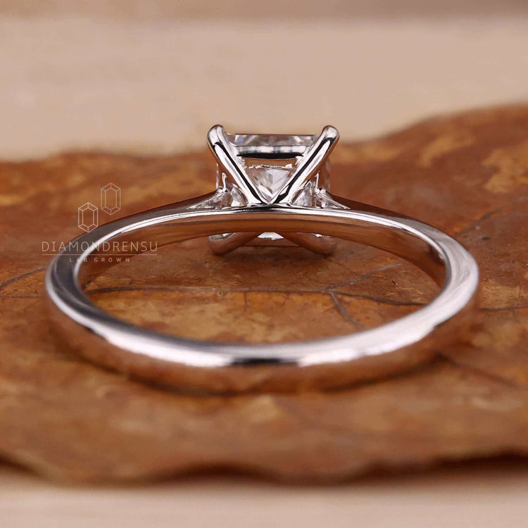 Cathedral setting engagement ring with a tapered shank.