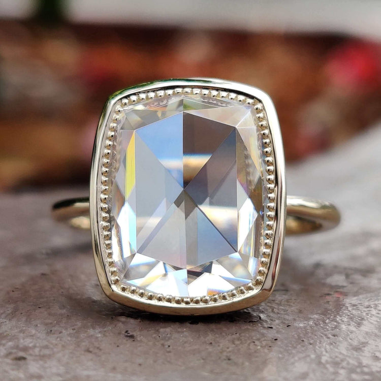 Bezel solitaire engagement ring with cushion rose cut moissanite.
