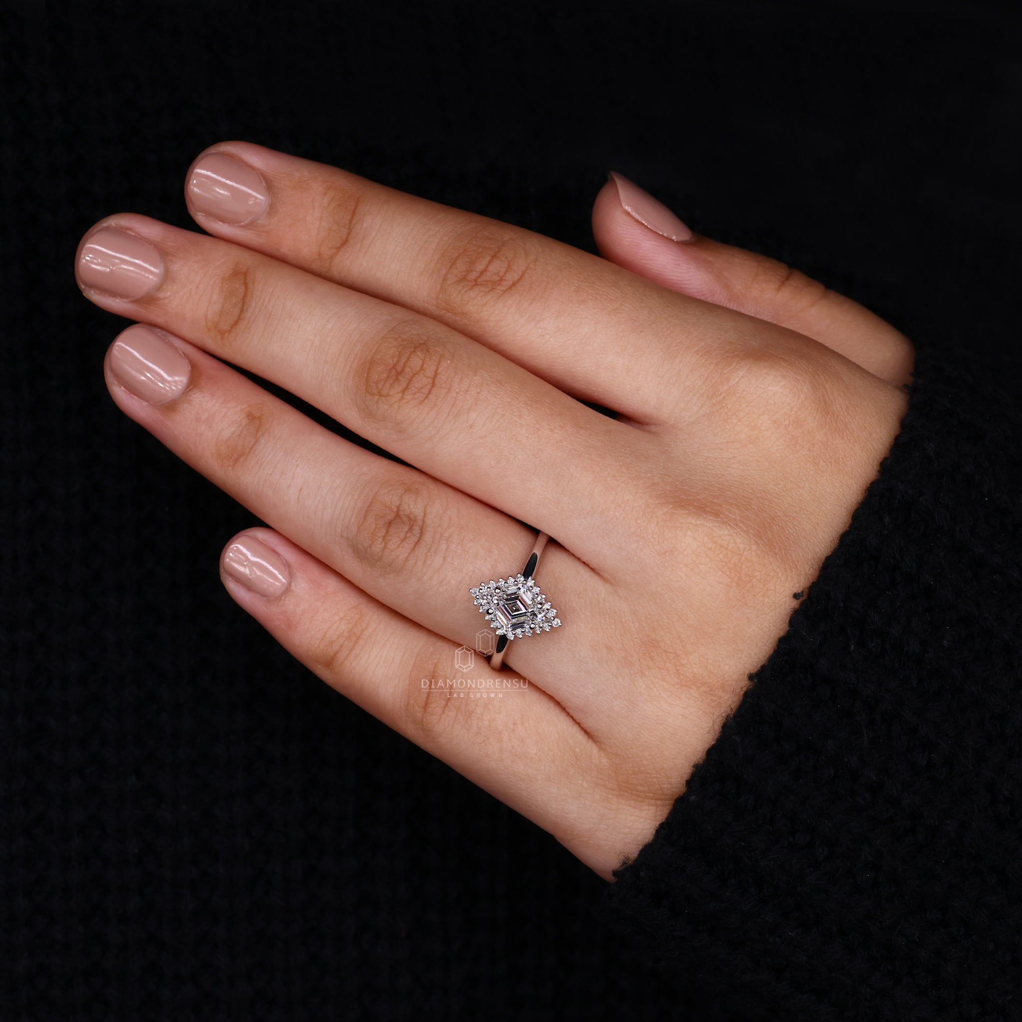 UK engagement ring with lozenge cut diamond and halo diamond setting.
