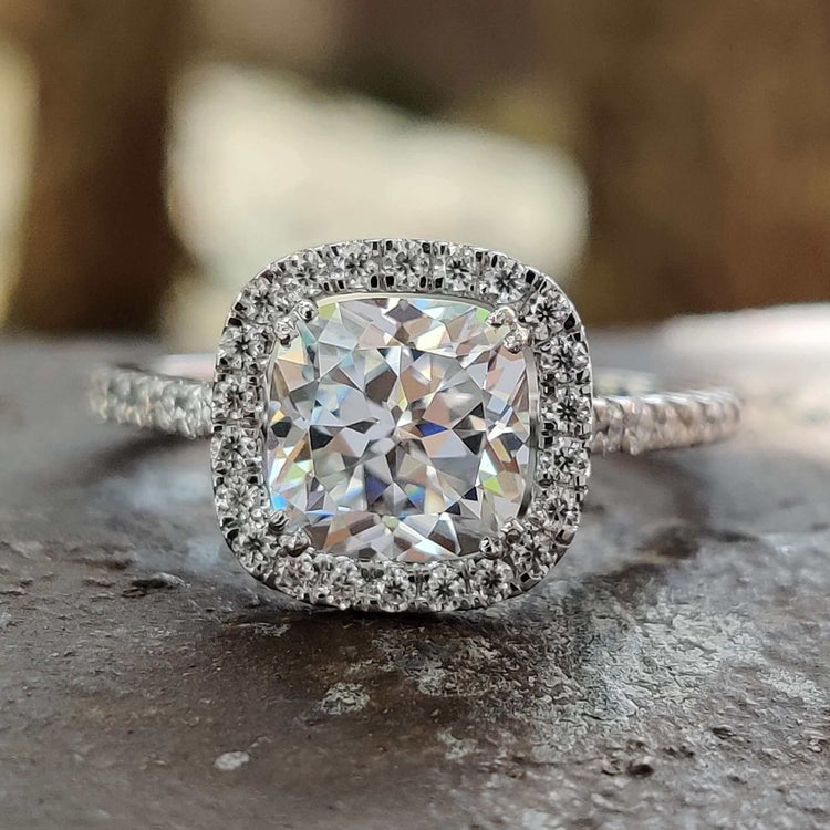 Halo pave engagement ring with cushion Rensu cut moissanite in white gold.
