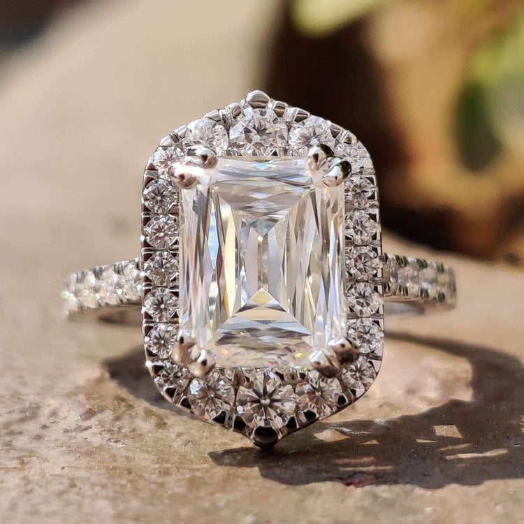 Criss cut moissanite engagement ring with round halo setting.
