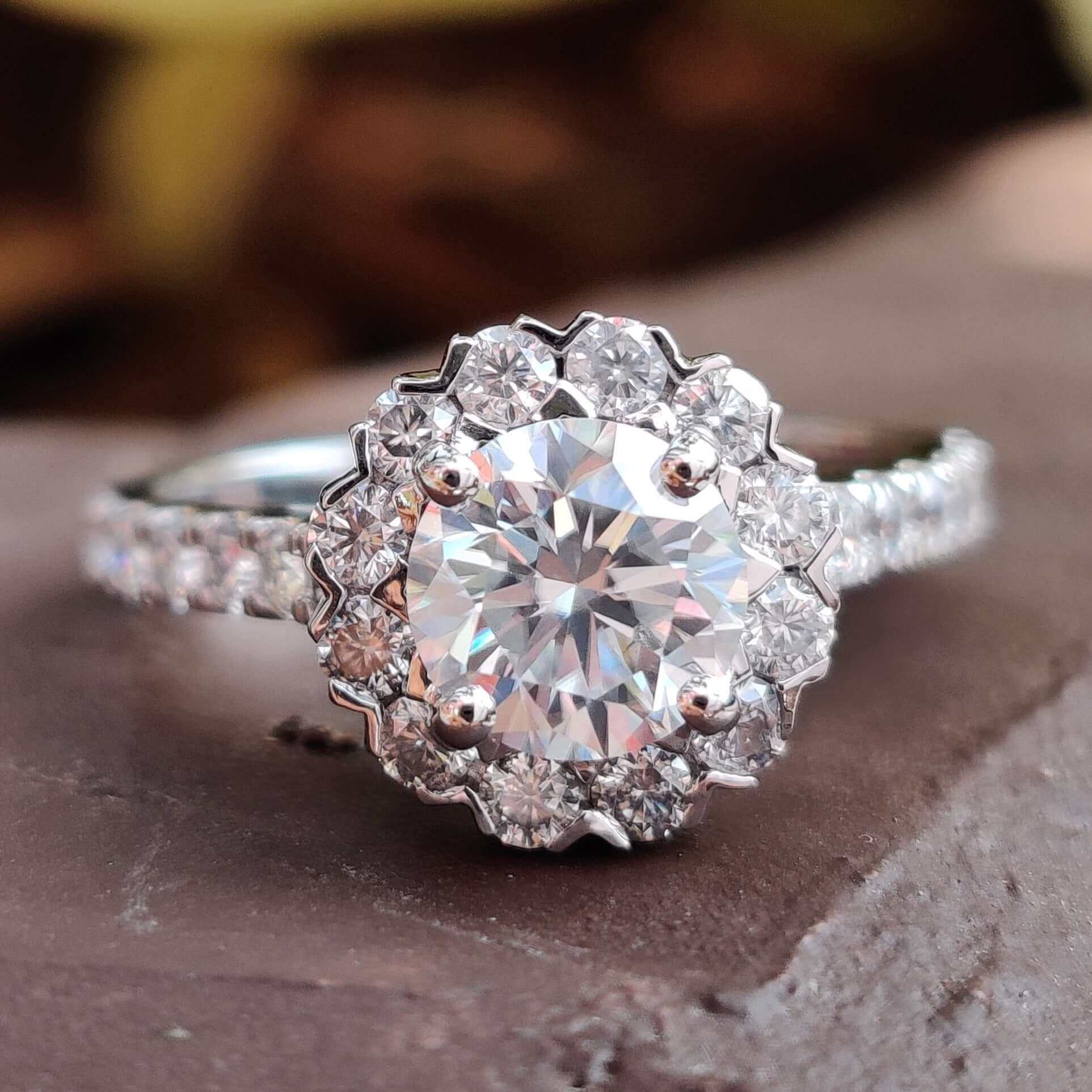 Elegant Halo Engagement Ring featuring a sparkling moissanite centre stone.
