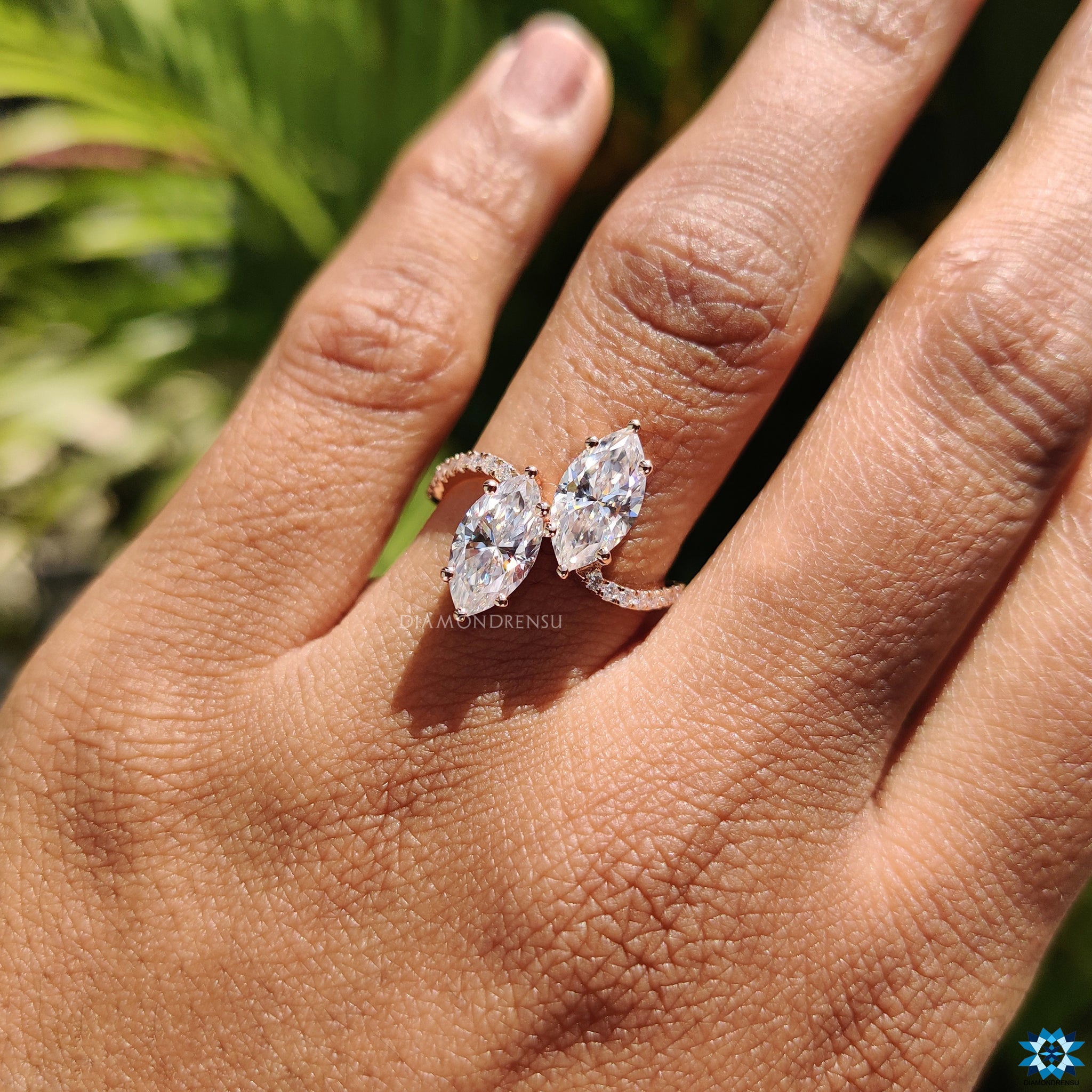 Custom engagement ring with rose gold band and marquise cut moissanite.
