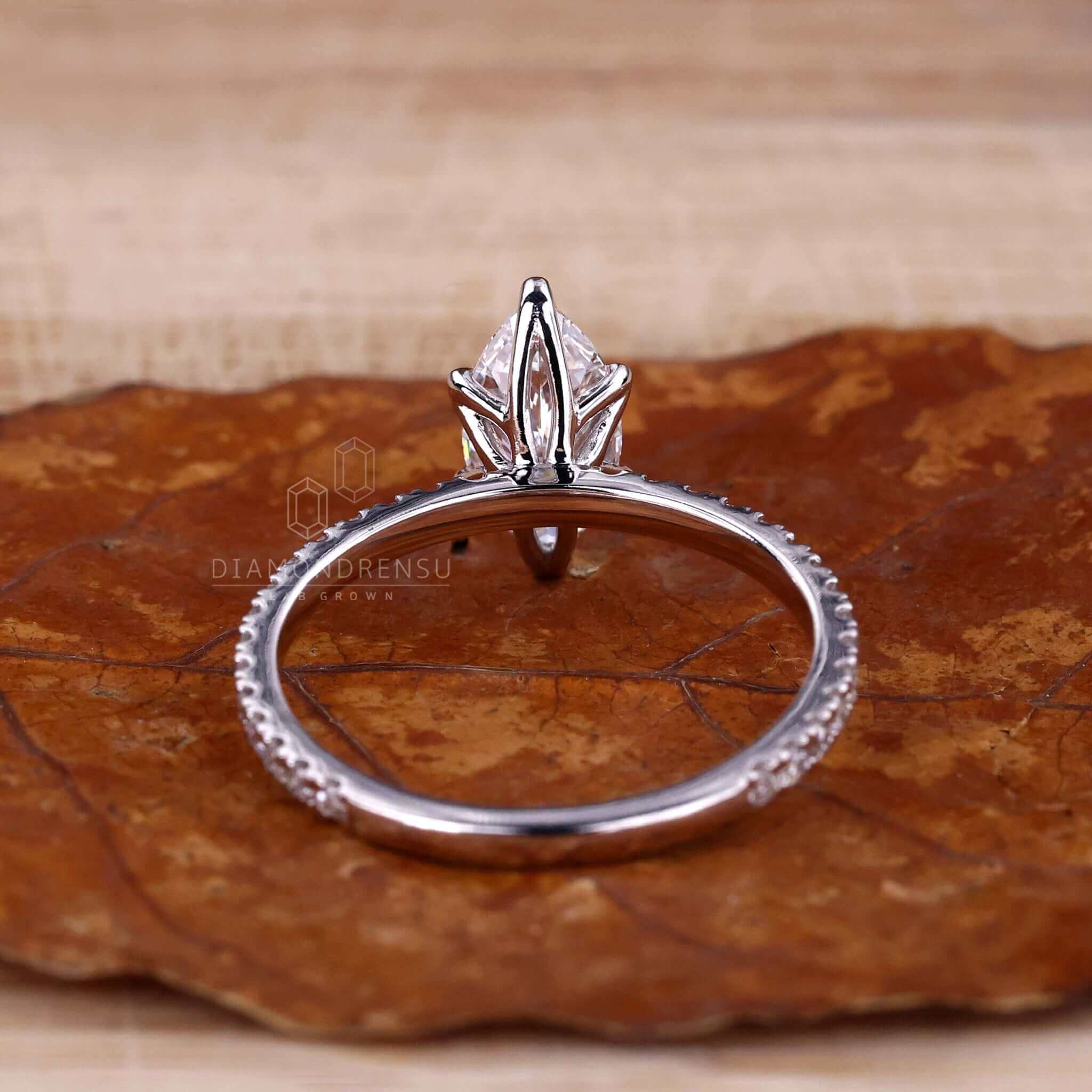 Prong setting engagement ring showcasing a marquise cut diamond.