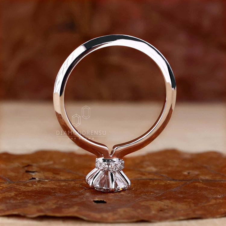 Round diamond engagement ring with a knife edge shank, ideal for creating a modern and elegant look.

