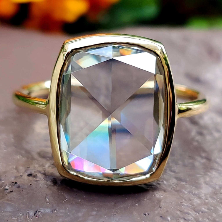 Elongated cushion cut moissanite engagement ring in yellow gold.
