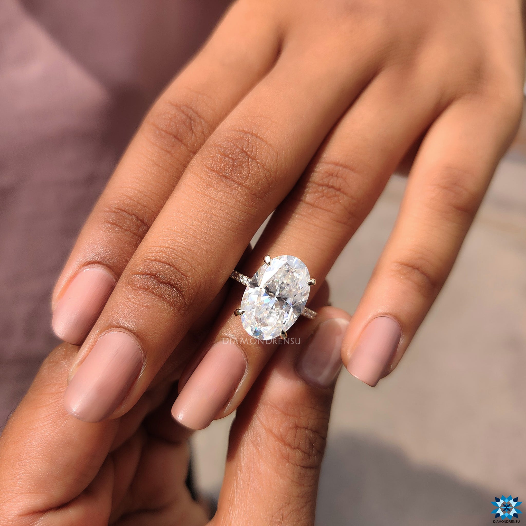 Handmade oval moissanite ring with 4 claw prong setting and hidden halo detail.
