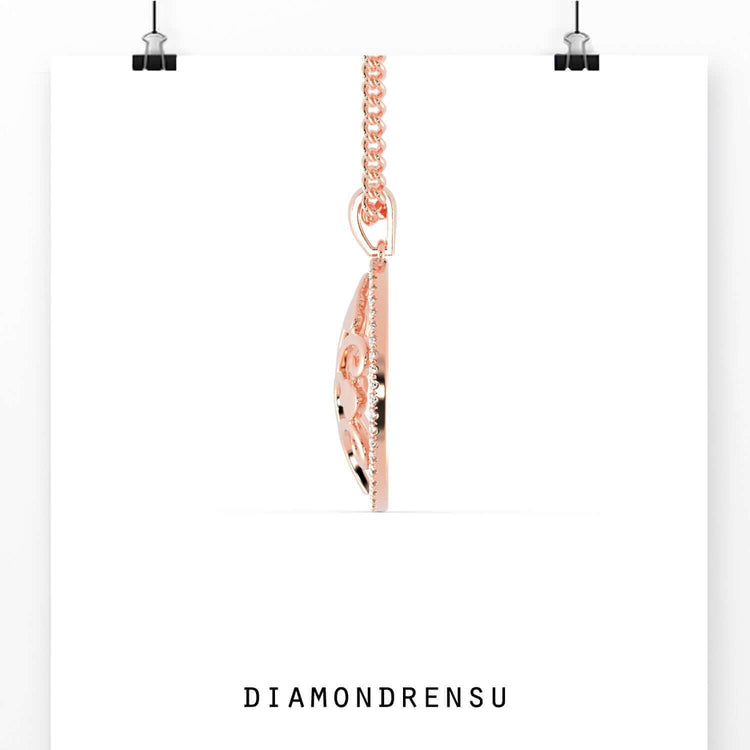 Round diamond outline pendant in rose gold with tree motif.
