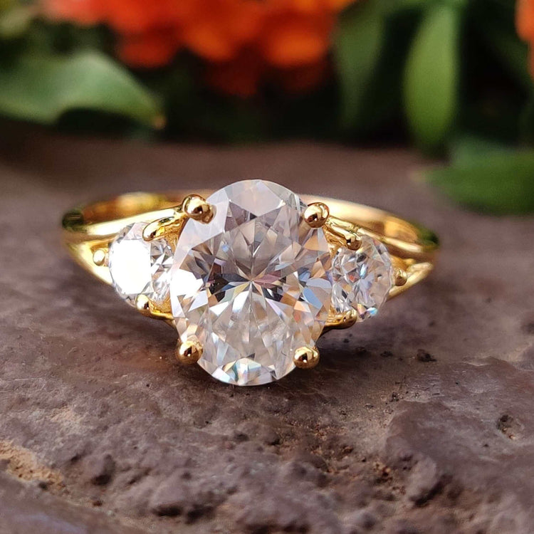 Yellow gold three stone moissanite engagement ring.
