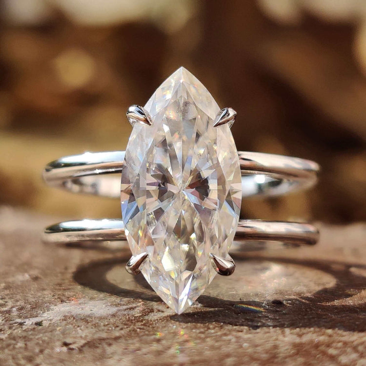 Marquise moissanite engagement ring with dual shank design.
