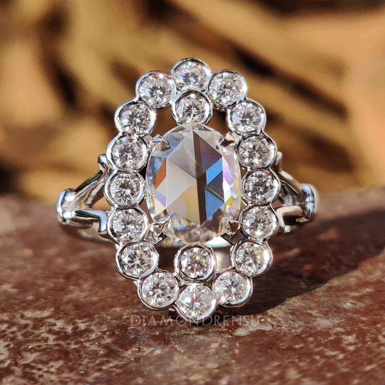 Oval rose cut engagement ring in a white gold halo setting.
