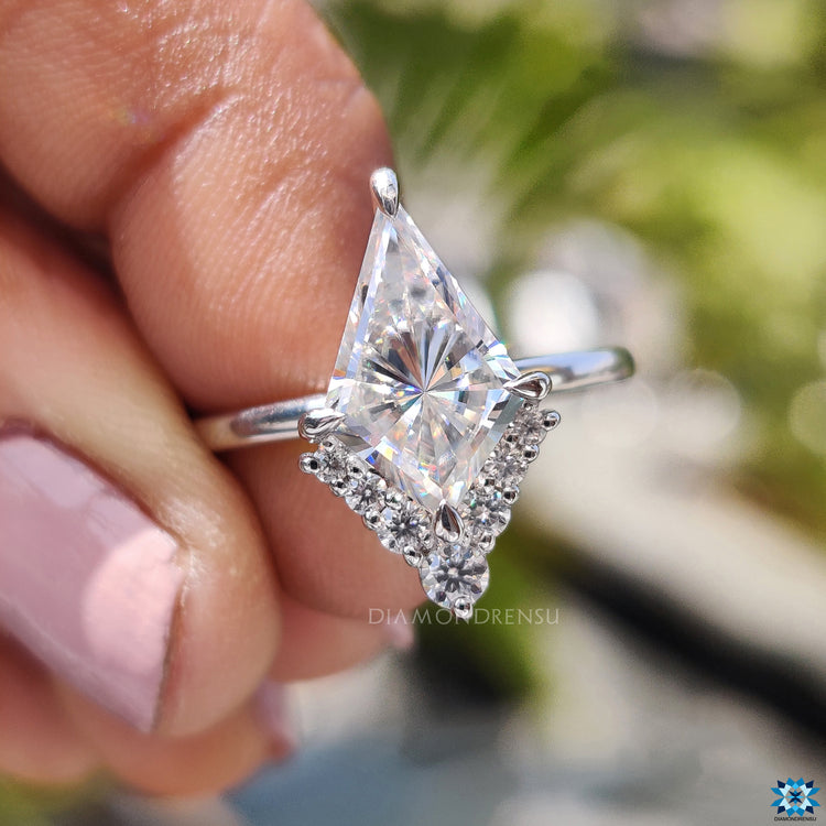 Handmade kite cut moissanite ring with white gold and compass prongs.
