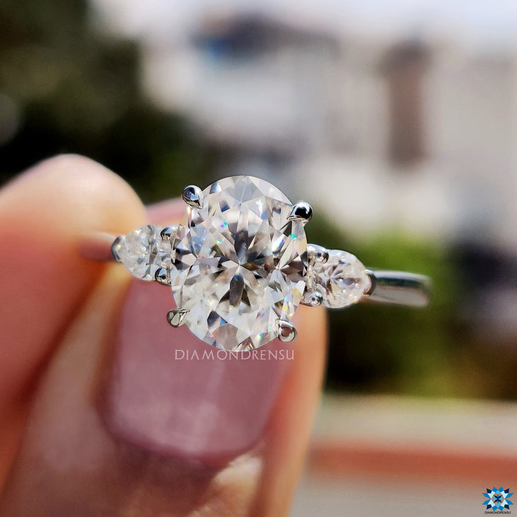 Oval and pear cut moissanite ring in claw prong setting.
