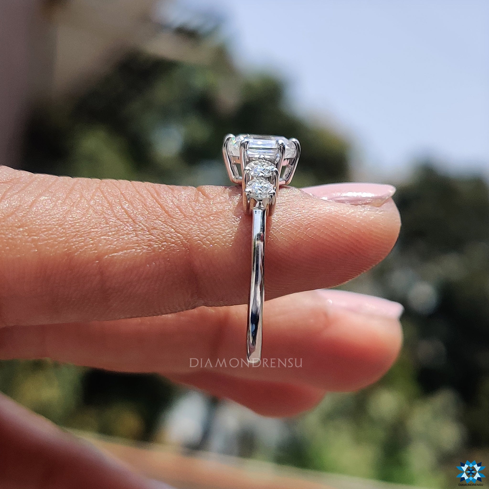 White gold hexagon ring with prong setting and round moissanite accents.
