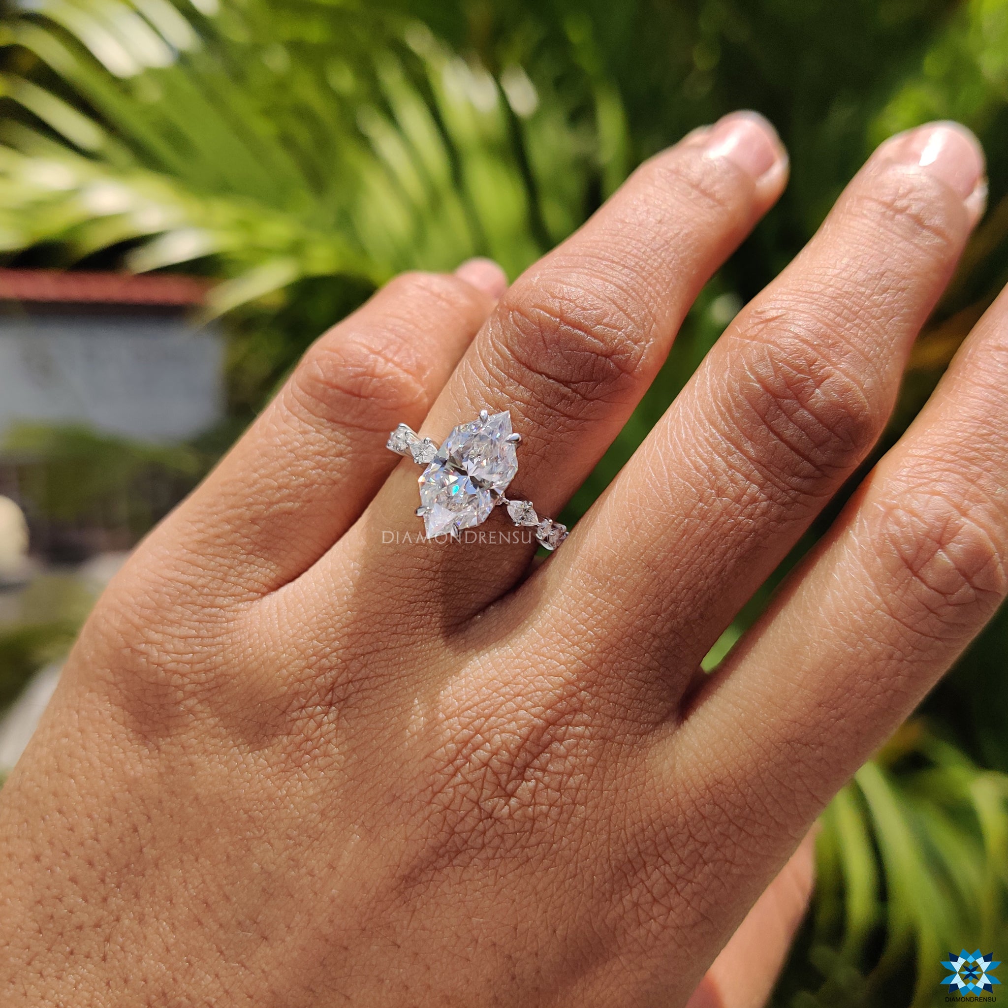 Round cut hidden halo setting surrounding Dutch marquise moissanite centre stone.
