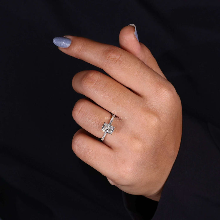 Elongated cushion cut engagement ring with pave band engagement ring details.
