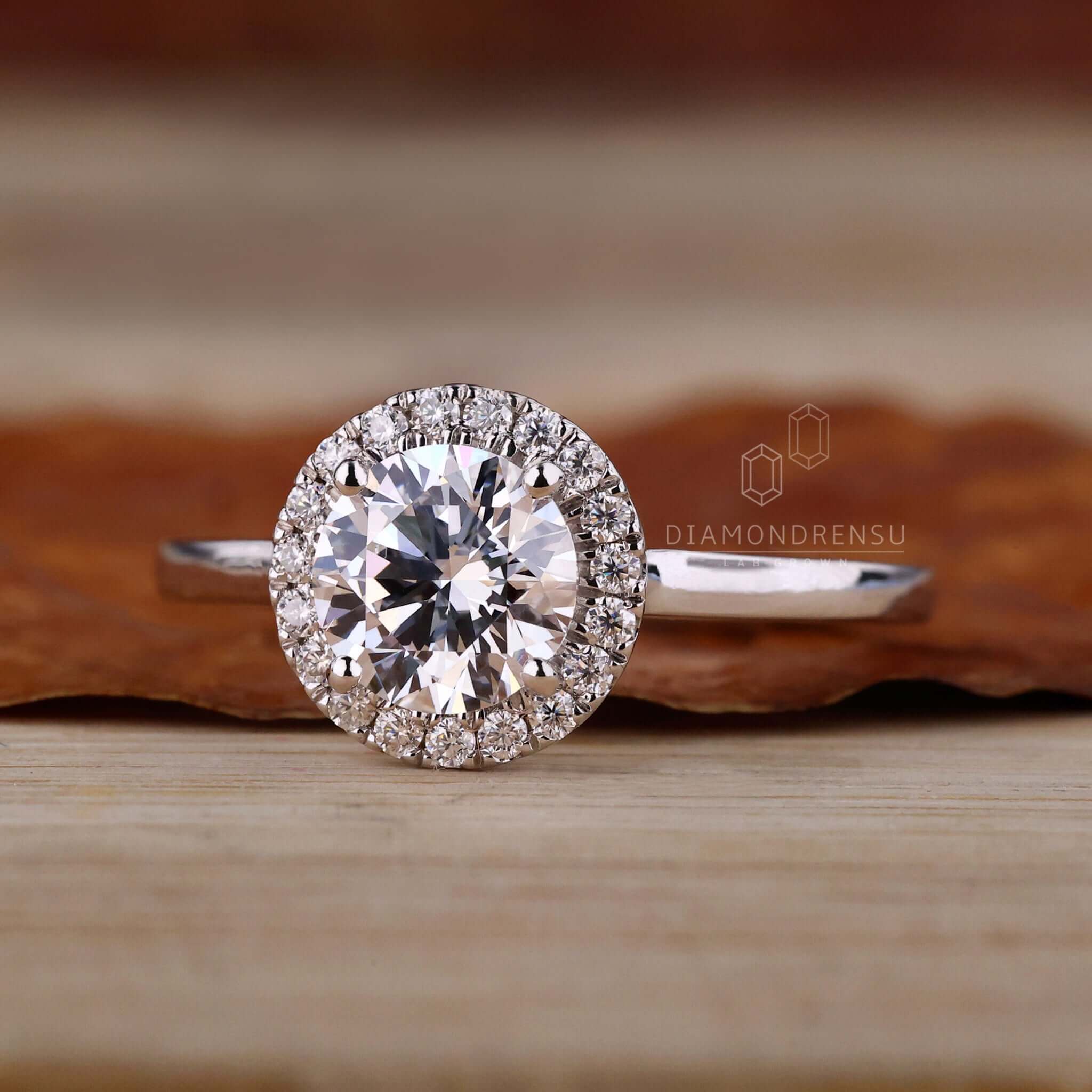 Halo ring setting with a 4 prong round diamond engagement ring, showcasing elegant craftsmanship.
