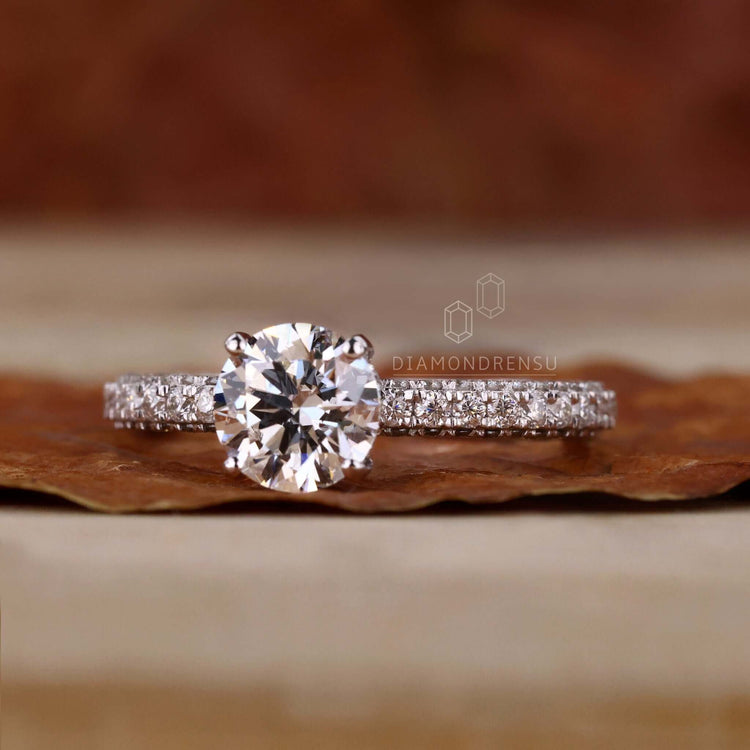 Three side pave setting with a 4 prong diamond ring, combining classic beauty with modern craftsmanship.
