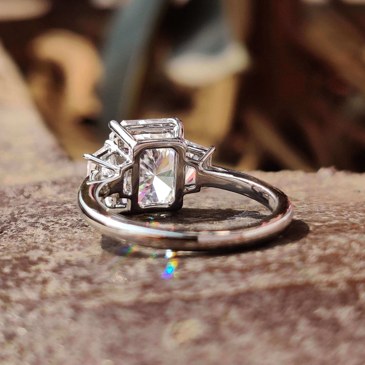 Moissanite ring with trapezoid side stones.
