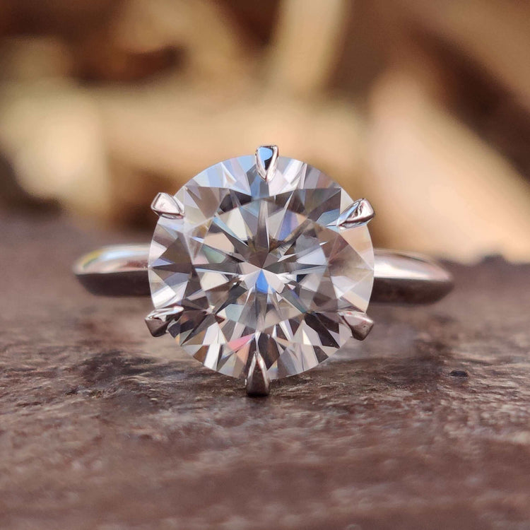 Round cut moissanite engagement ring in white gold.
