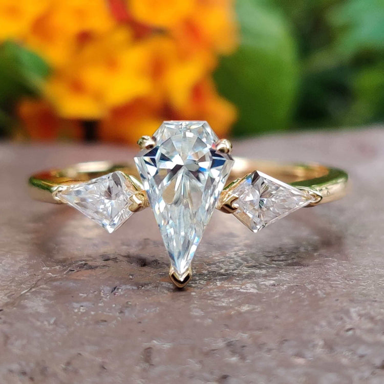 Spear cut moissanite engagement ring in yellow gold.
