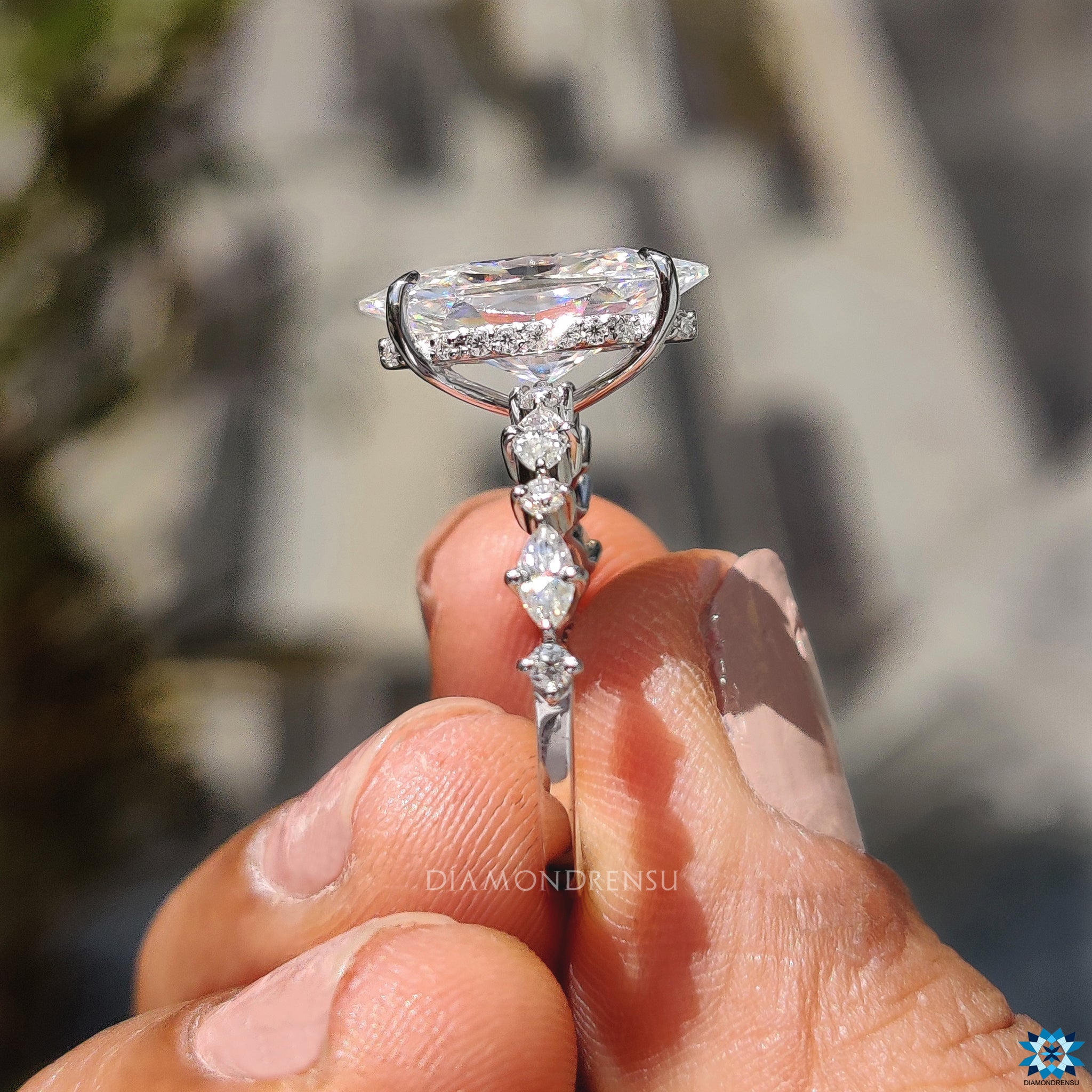 Buy engagement ring featuring Dutch marquise and round cut hidden halo.
