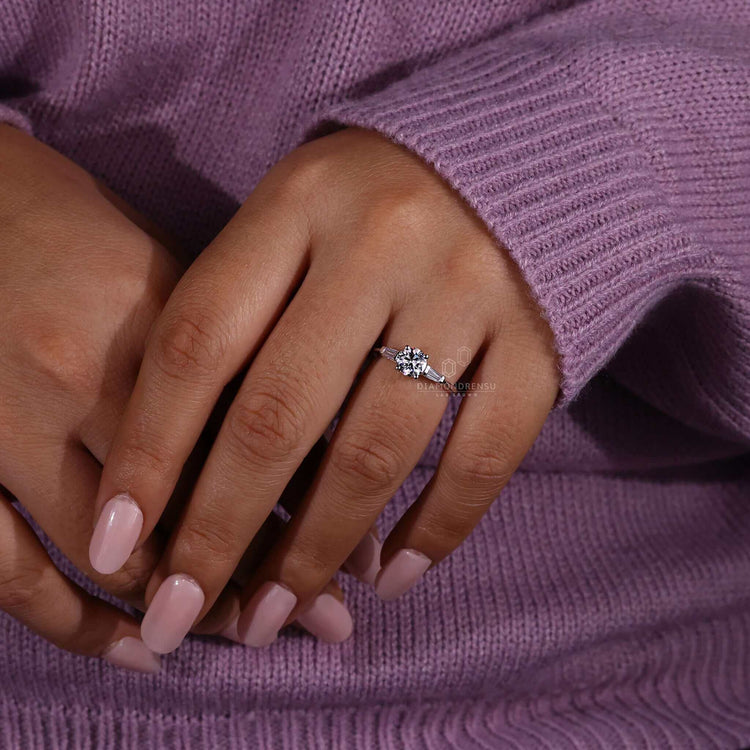 3 stone diamond engagement ring crafted with a round cut diamond and diamond tapered baguettes for extra brilliance.
