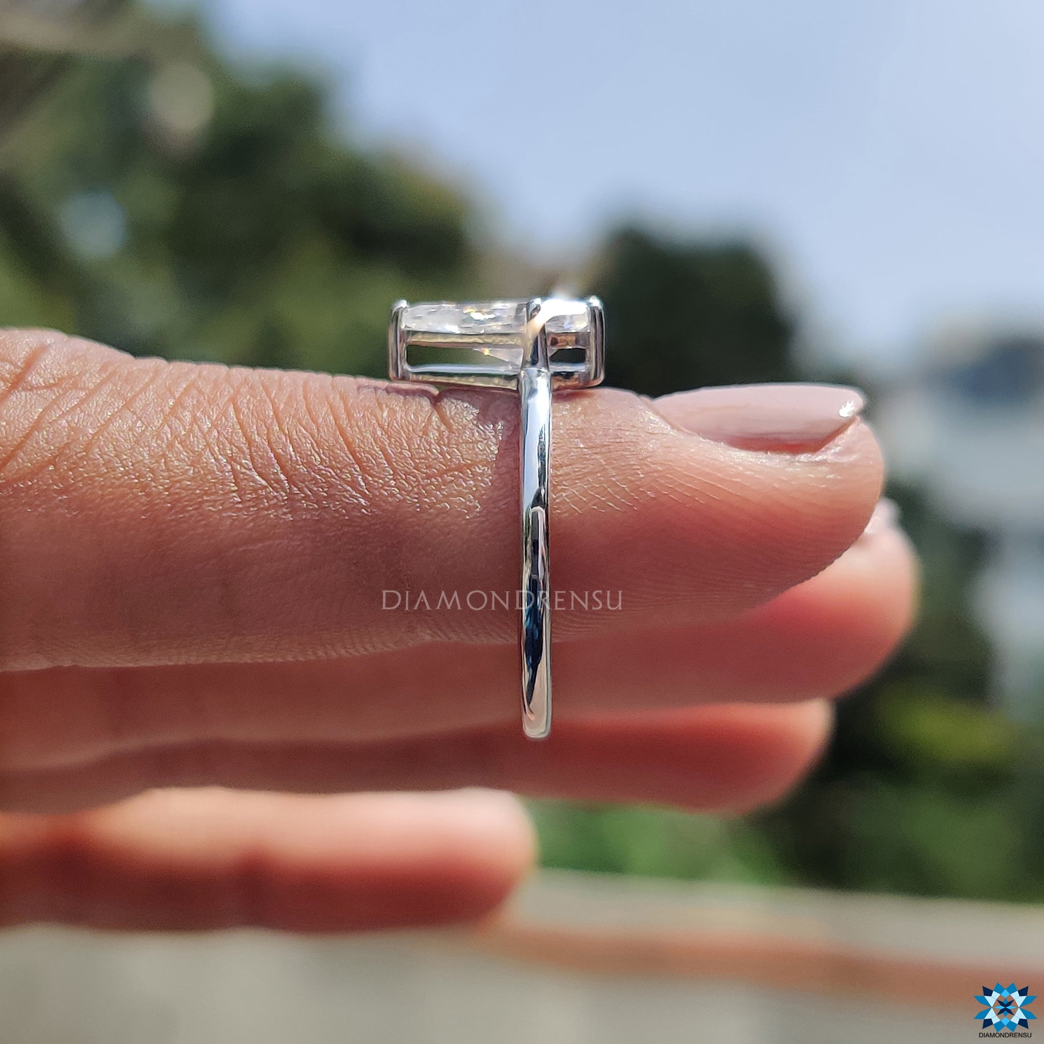 Prong setting ring with spear cut moissanite and handmade white gold band.
