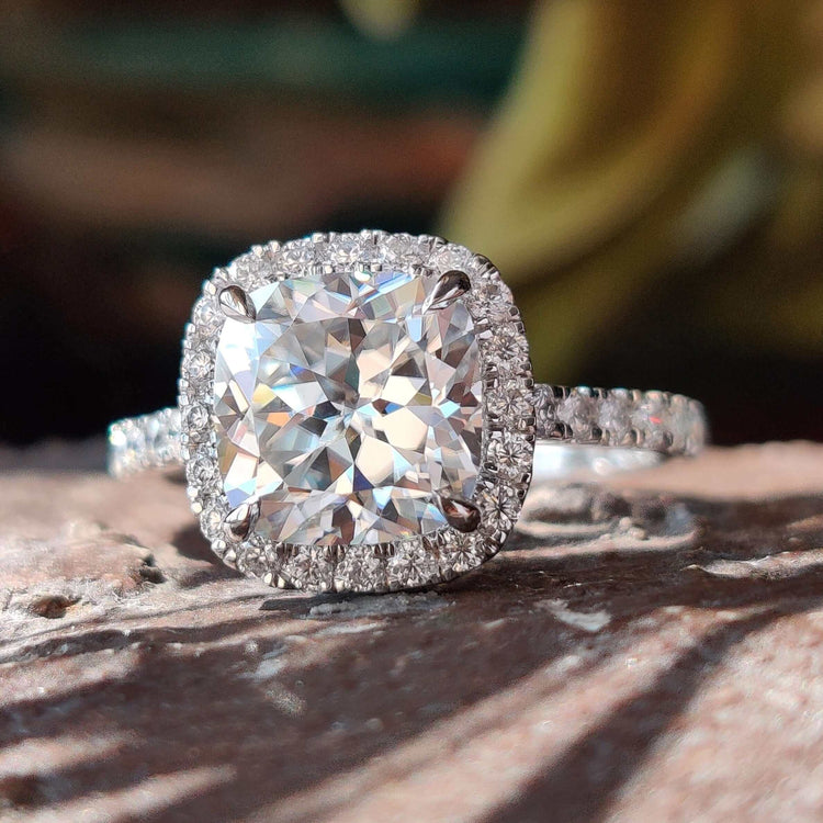 Cushion Rensu cut moissanite ring with halo and pave setting.

