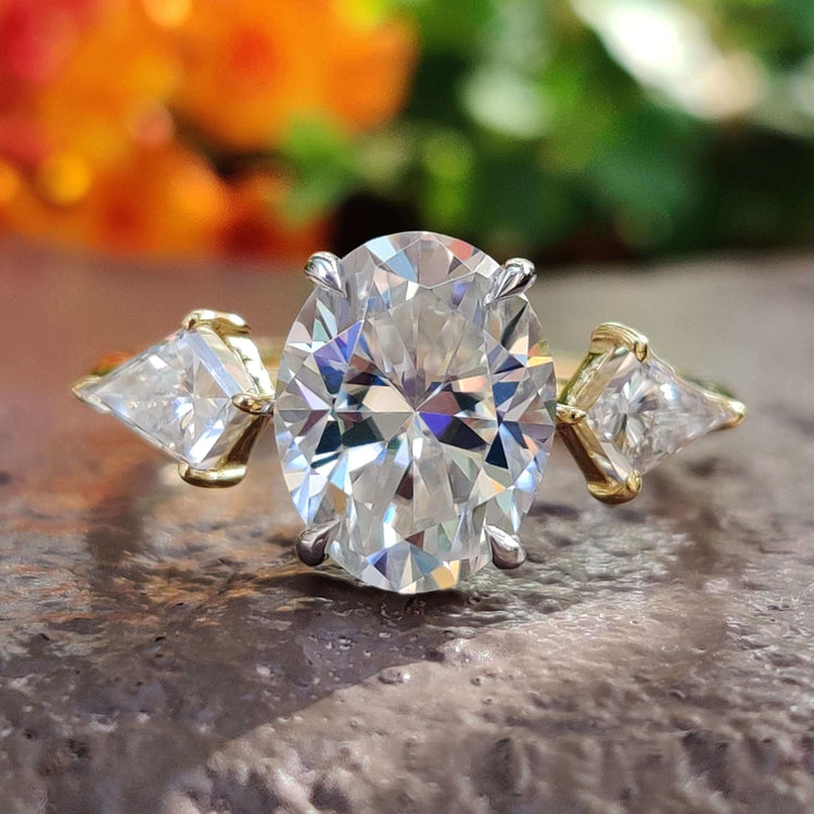 Oval cut moissanite ring in yellow gold.
