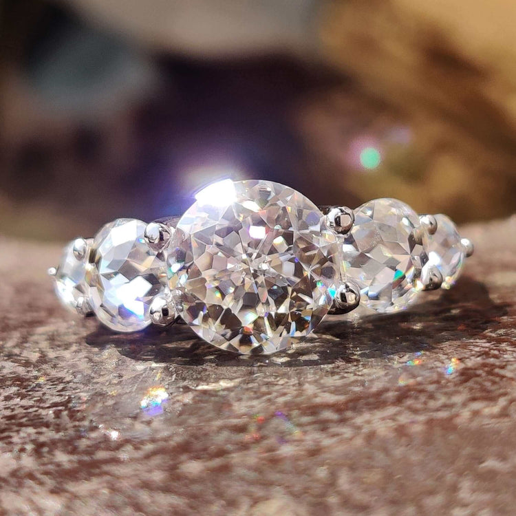 Five stone moissanite ring with jubilee cut center stone.
