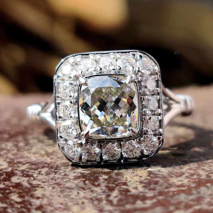 Bezel set moissanite ring with cushion divine cut stone.
