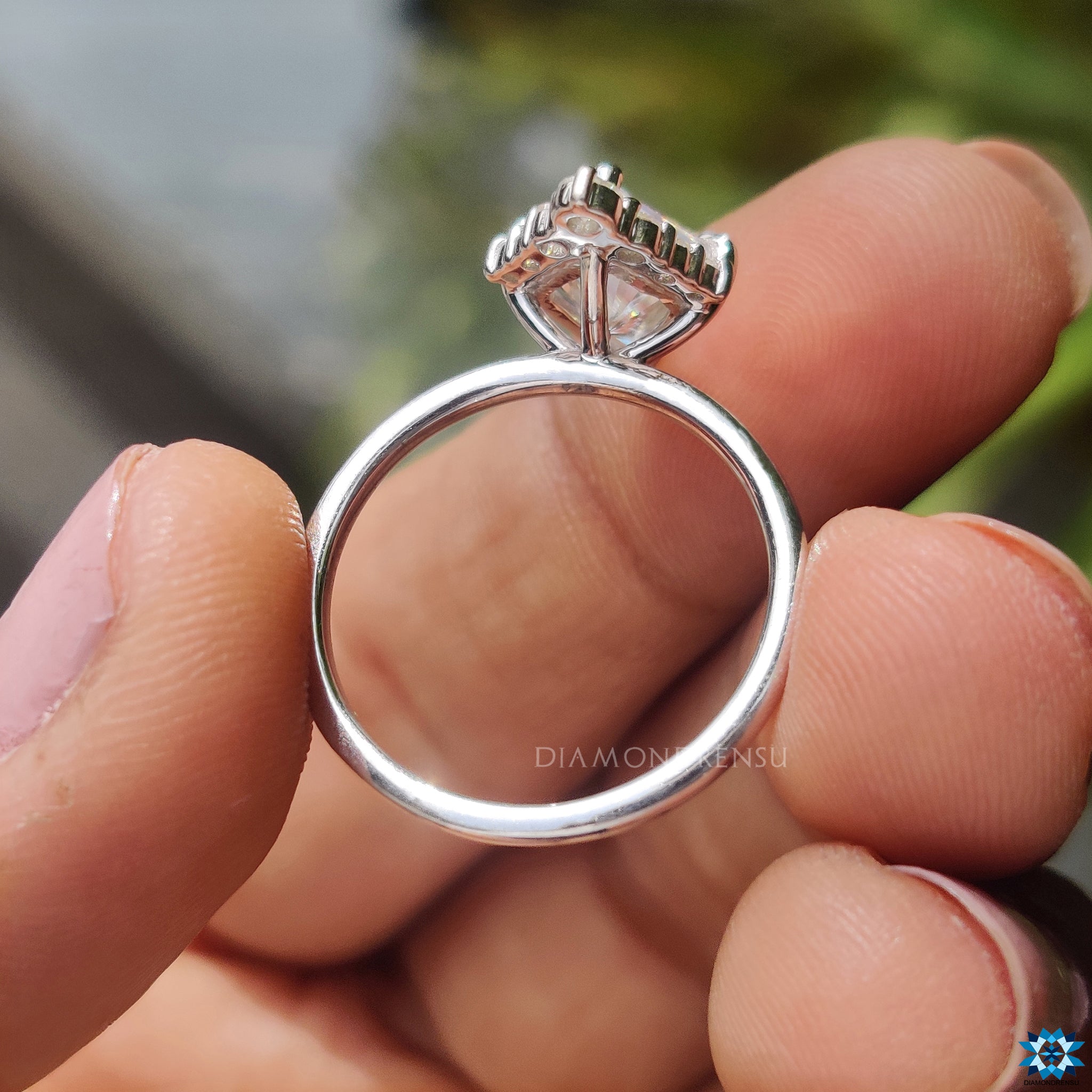 Diamondrensu UK engagement ring featuring kite cut centre and halo setting.

