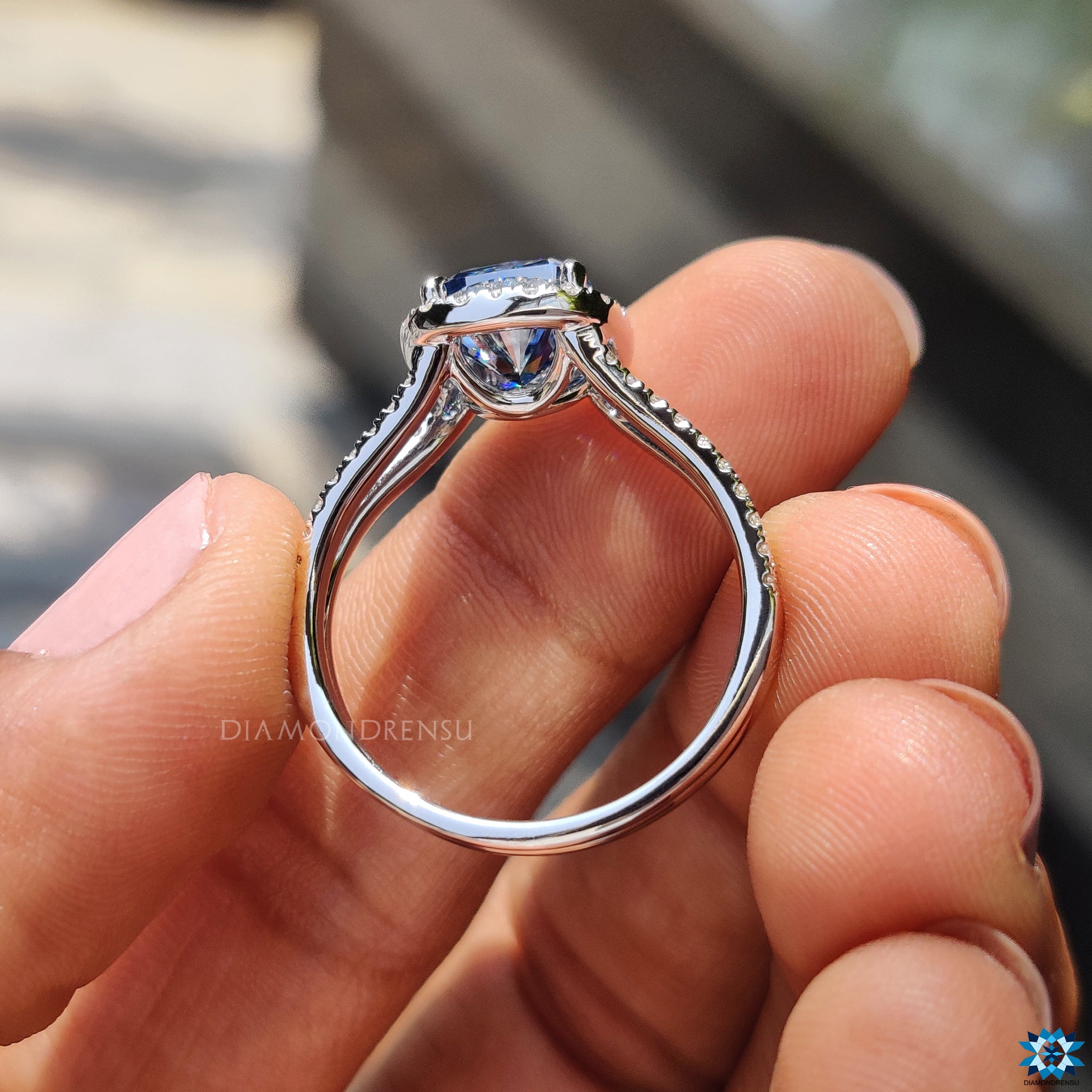 UK engagement ring with split shank and royal blue moissanite in cushion cut.

