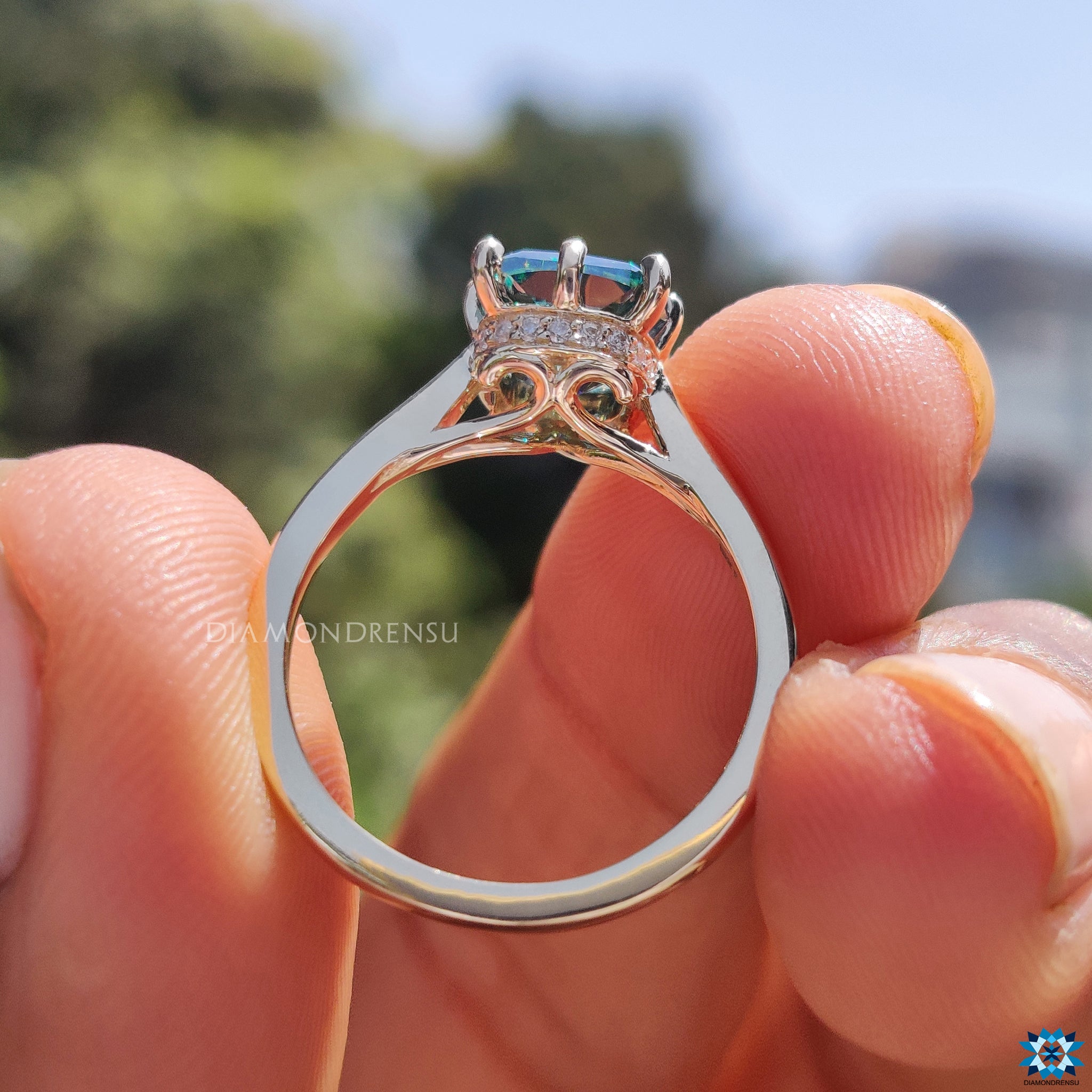 Tapered shank band supporting cushion cut moissanite in hidden halo style.
